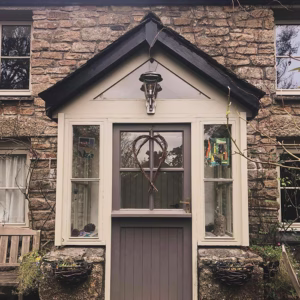 Charming stone cottage entrance with outdoor light installed by AMP Electrical Solutions